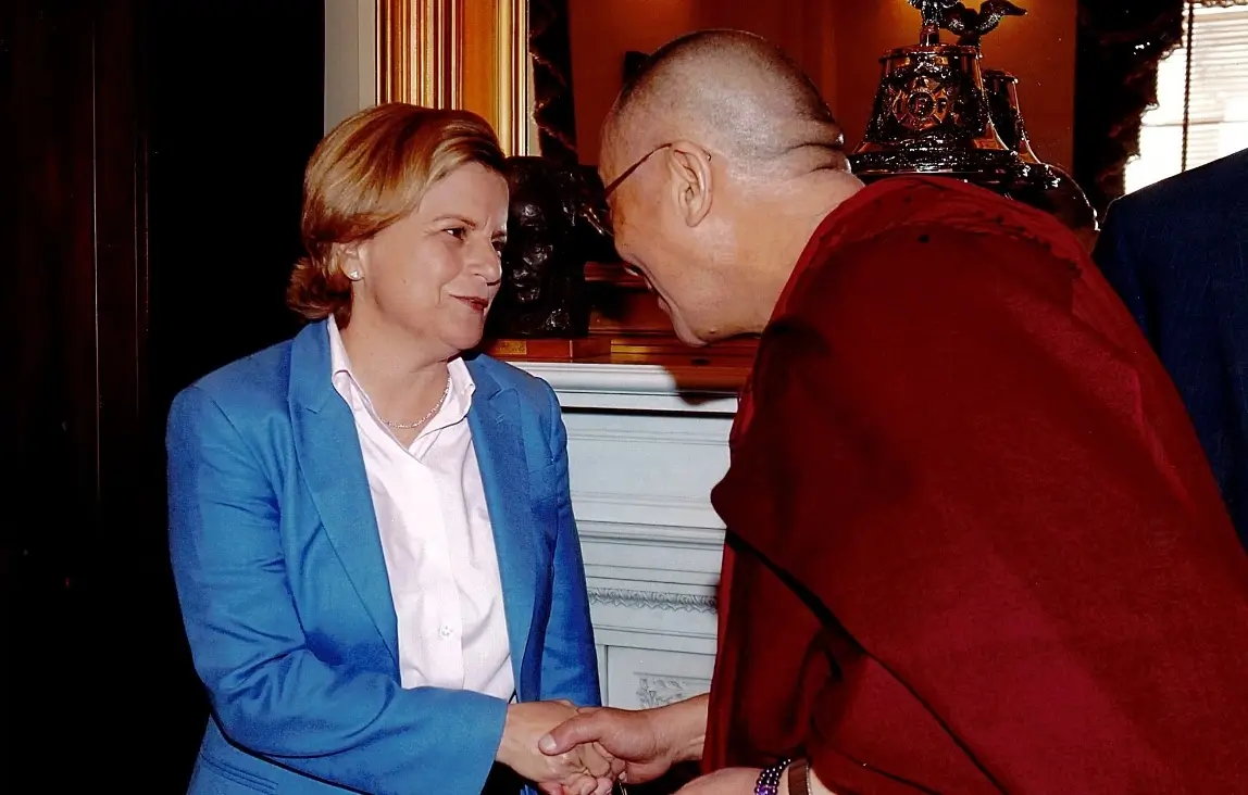 Ileana Ros-Lehtinen shaking hands with the Dalai Lama